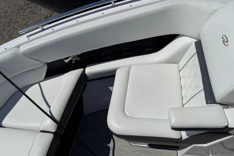 Slide: The Image of 2018 Regal 2800 Bowrider interior with white leather seating and cup holders. - 8