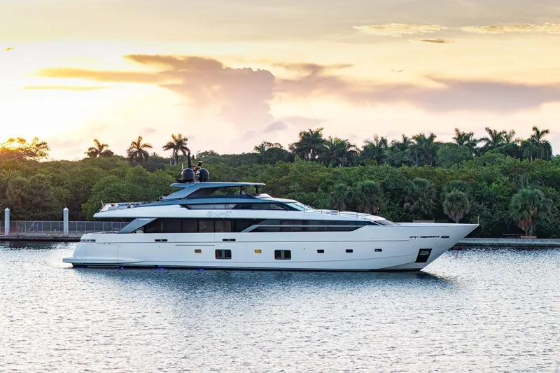 The Image of Luxurious 2023 Sanlorenzo SL 120A yacht cruising at sunset near lush greenery. - 0
