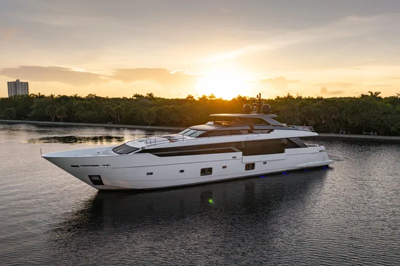 Slide: The Image of Luxurious 2023 Sanlorenzo SL 120A yacht cruising at sunset on a serene waterway. - 1