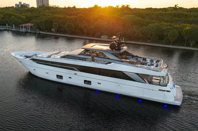 Slide: The Image of Luxury 2023 Sanlorenzo SL120A yacht cruising at sunset on a serene waterway. - 2
