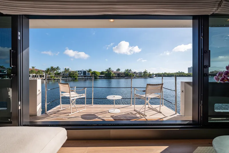 Slide: The Image of Luxurious Sanlorenzo SL120A yacht deck with chairs overlooking serene waterfront, 2023 model. - 20