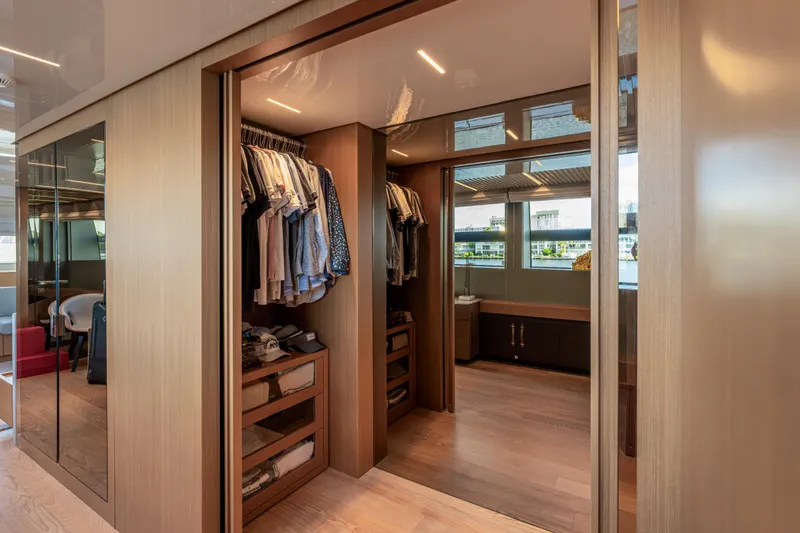Slide: The Image of Luxurious walk-in closet on 2023 Sanlorenzo SL120A yacht, featuring elegant wood finishes. - 32