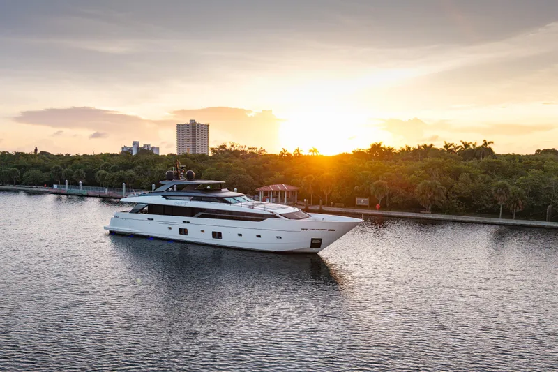 Slide: The Image of 2023 Sanlorenzo SL120A yacht cruising at sunset on a serene waterway. - 4