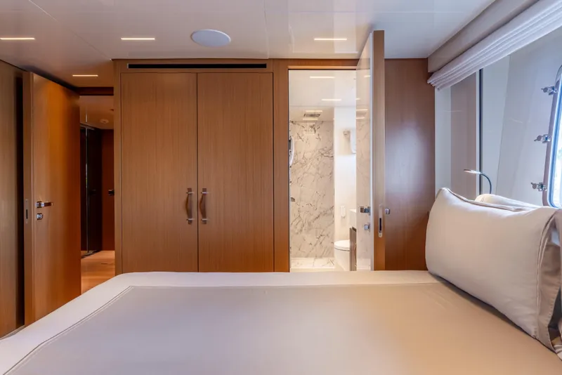 Slide: The Image of Luxurious 2023 Sanlorenzo SL120A yacht bedroom with ensuite bathroom and elegant wood finishes. - 46