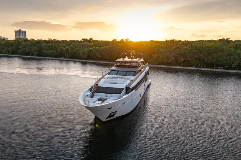 Slide: The Image of 2023 Sanlorenzo SL120A yacht cruising at sunset on a serene waterway. - 5