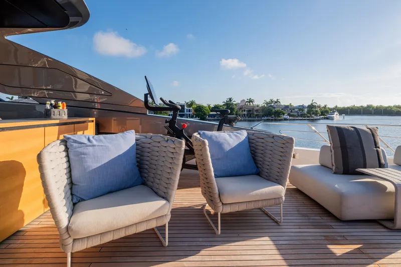 Slide: The Image of Luxurious 2023 Sanlorenzo SL120A yacht deck with stylish seating and scenic waterfront view. - 53