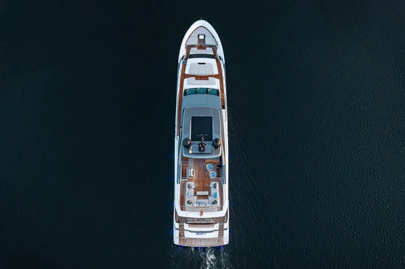 Slide: The Image of Aerial view of 2023 Sanlorenzo SL120A yacht cruising on dark water. - 7