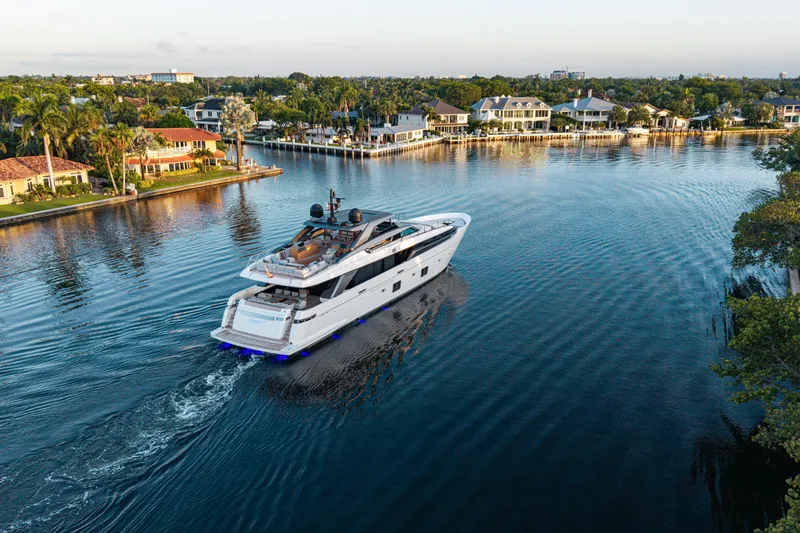 Slide: The Image of Luxury 2023 Sanlorenzo SL120A yacht cruising near waterfront homes. - 8