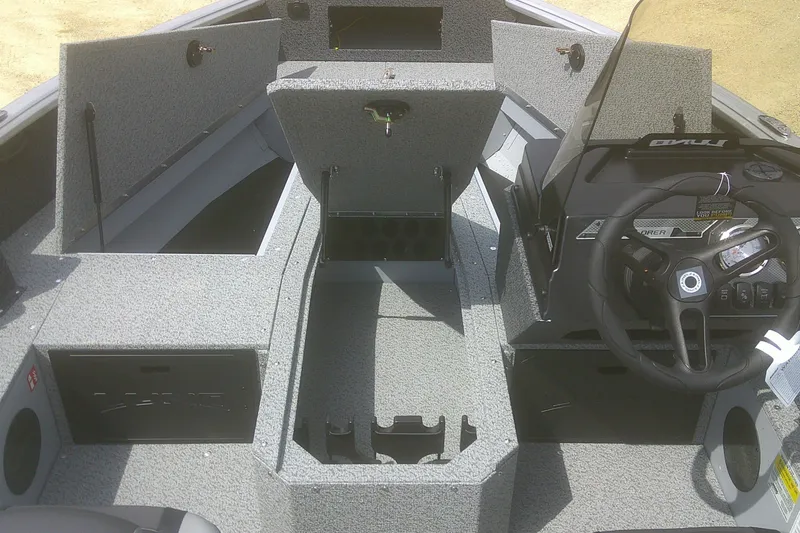 Slide: The Image of 2026 Lund 1800 Explorer SS boat interior with storage compartments and steering console. - 5