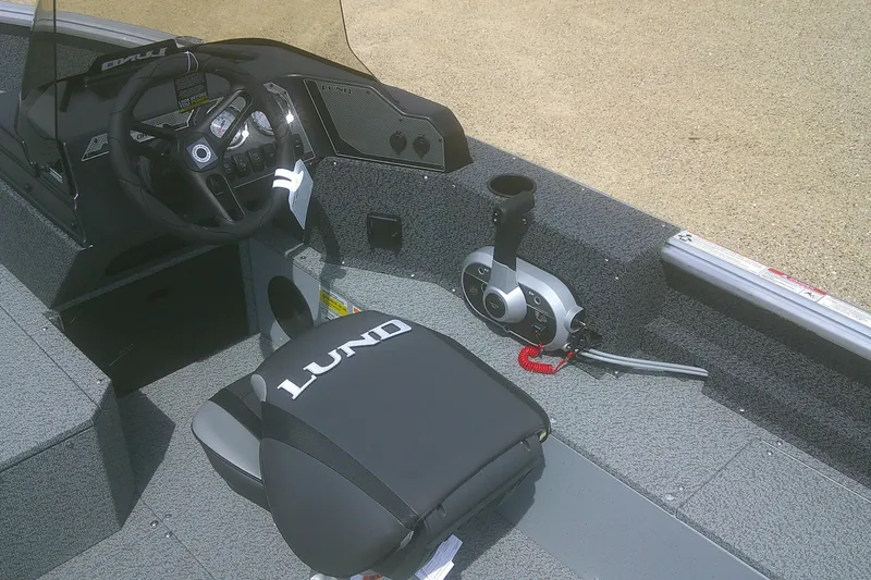 Slide: The Image of 2026 Lund 1800 Explorer SS boat interior with steering wheel and control panel. - 9
