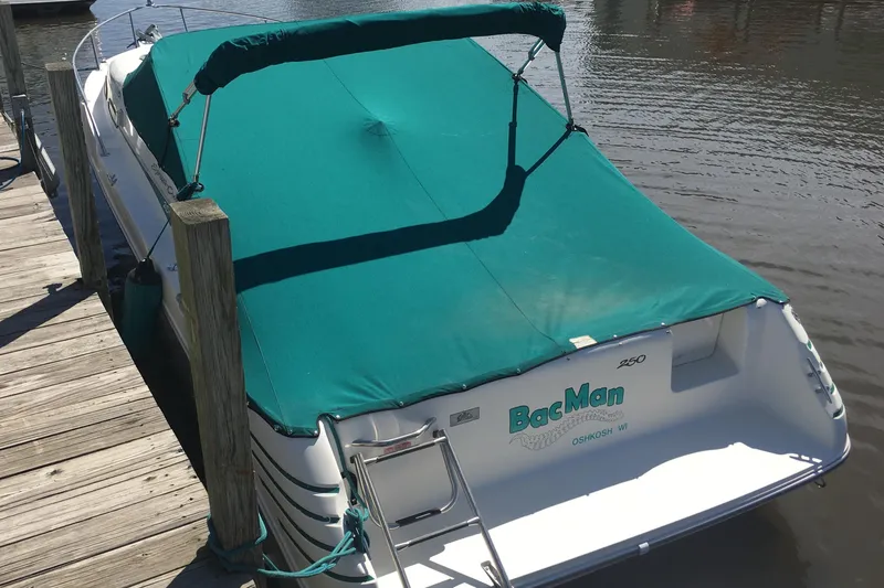 Slide: The Image of 1993 Sea Ray 250 Sundancer docked, covered with a green canopy. - 5