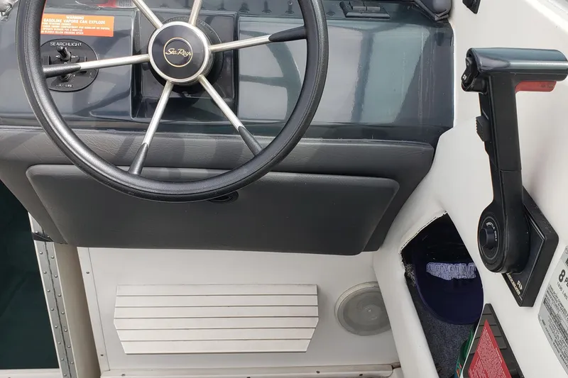 Slide: The Image of 1993 Searay 250EC boat dashboard with steering wheel and control lever. - 6