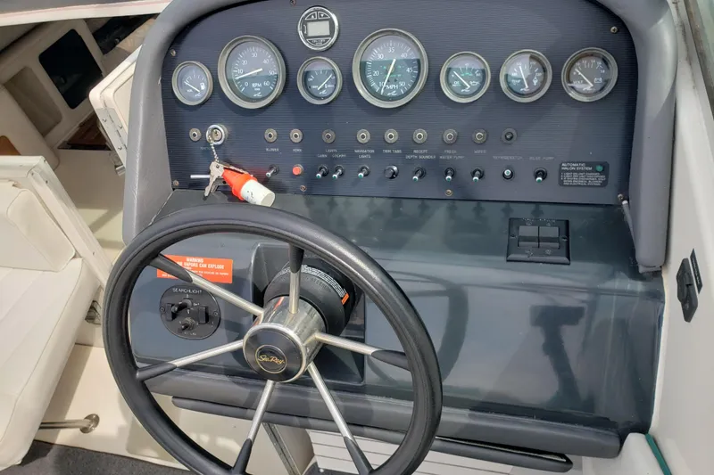 Slide: The Image of 1993 Searay 250EC boat dashboard with steering wheel and instrument panel. - 7