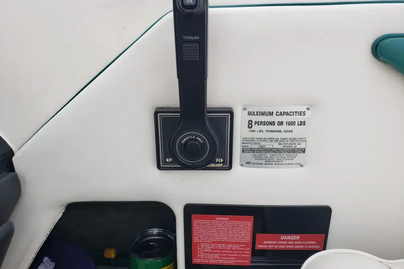 Slide: The Image of 1993 Searay 250EC boat control panel with capacity label for 8 persons or 1600 lbs. - 9