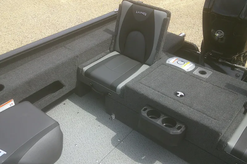 Slide: The Image of 2026 Lund 1675 Adventure SS boat interior with cushioned seating and storage compartments. - 10