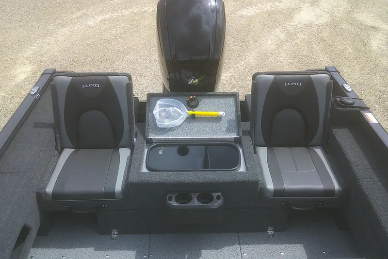 Slide: The Image of 2026 Lund 1675 Adventure SS boat interior with two seats and storage compartments. - 11