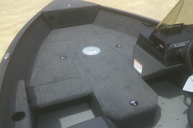 Slide: The Image of 2026 Lund 1675 Adventure SS boat interior with carpeted deck and console. - 3