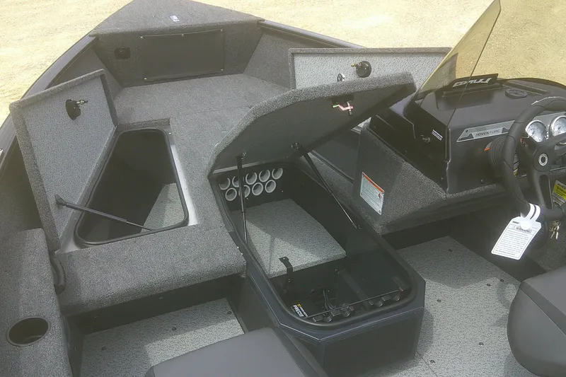 Slide: The Image of 2026 Lund 1675 Adventure SS boat interior with storage compartments and steering console. - 4