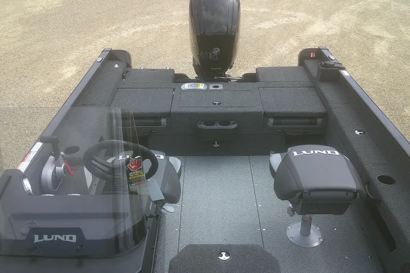 Slide: The Image of 2026 Lund 1675 Adventure SS boat interior with steering wheel and seating. - 5