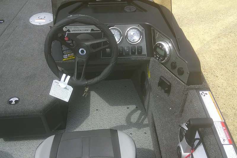 Slide: The Image of 2026 Lund 1675 Adventure SS boat dashboard with steering wheel and gauges. - 7