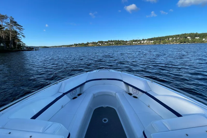 Slide: The Image of 2005 Formula 240 Bowrider on a serene lake under a clear blue sky. - 12