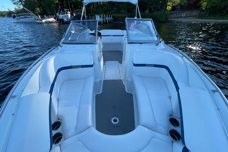 Slide: The Image of 2005 Formula 240 Bowrider boat with spacious seating on a calm lake. - 13