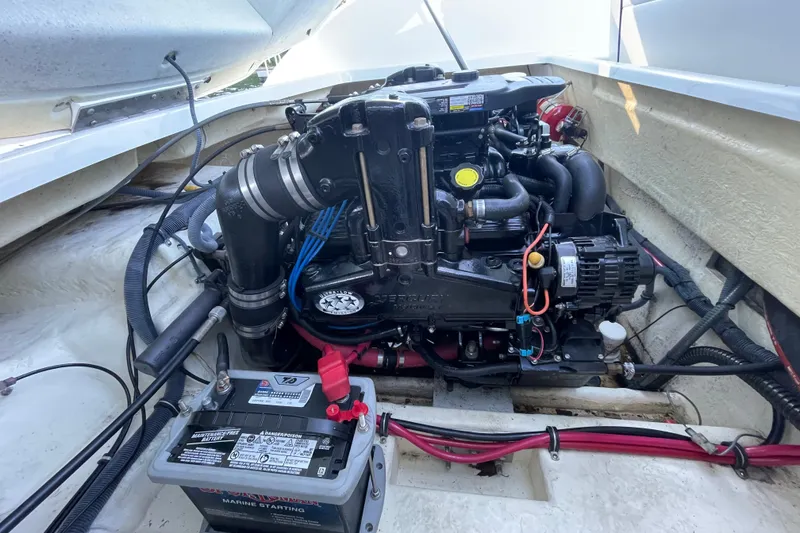 Slide: The Image of 2005 Formula 240 Bowrider engine compartment with battery and wiring visible. - 18