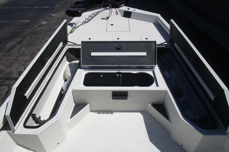 Slide: The Image of 2025 Ranger RB210 boat interior with open storage compartments and sleek design. - 13