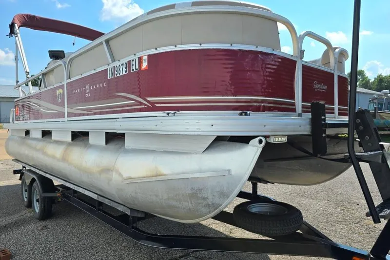 Slide: The Image of 2012 Sun Tracker 22 Party Barge Deluxe pontoon boat on trailer, red and white design. - 11