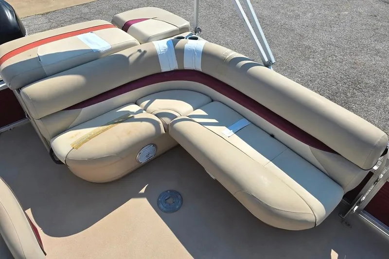 Slide: The Image of 2012 Sun Tracker 22 Party Barge Deluxe with beige seating and red accents. - 6