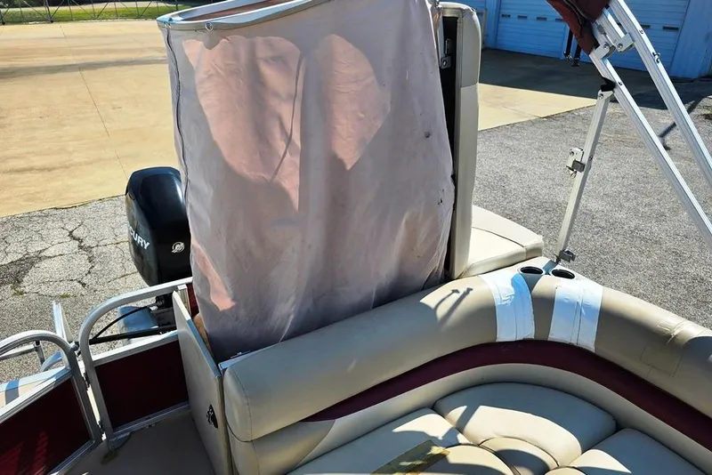 Slide: The Image of 2012 Sun Tracker 22 Party Barge Deluxe interior with seating and Mercury outboard motor. - 7