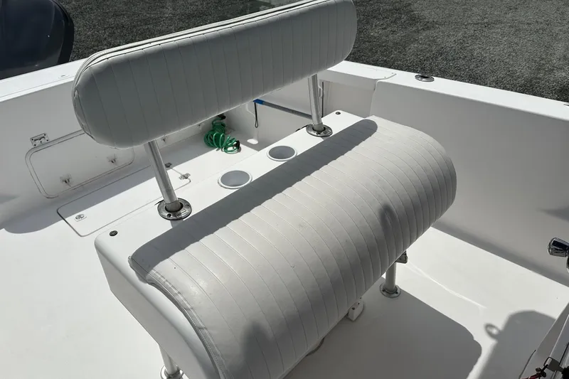 Slide: The Image of 2003 PROLINE Sport Center Console boat with white cushioned seating and cup holders. - 11