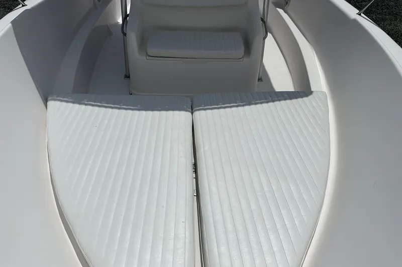 Slide: The Image of 2003 PROLINE Sport Center Console boat interior with white cushioned seating. - 15