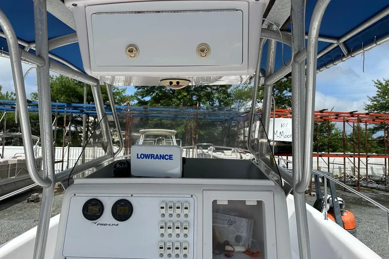 Slide: The Image of 2003 PROLINE Sport Center Console boat with Lowrance equipment, docked outdoors. - 3