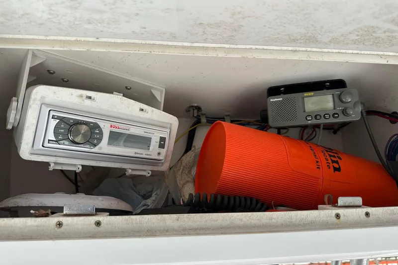 Slide: The Image of 2003 PROLINE Sport Center Console storage with radio, emergency kit, and equipment. - 6