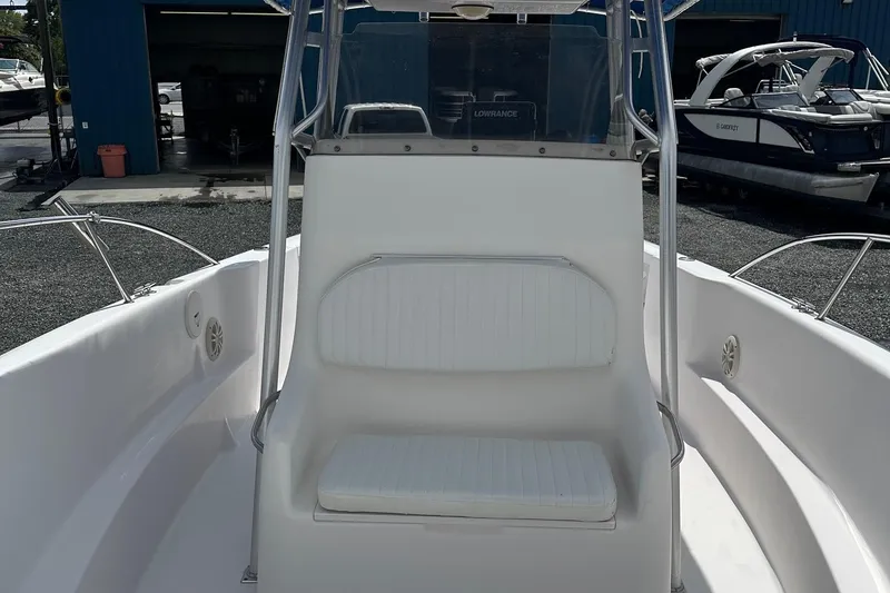Slide: The Image of 2003 PROLINE Sport Center Console boat interior with white seating and metal frame. - 8