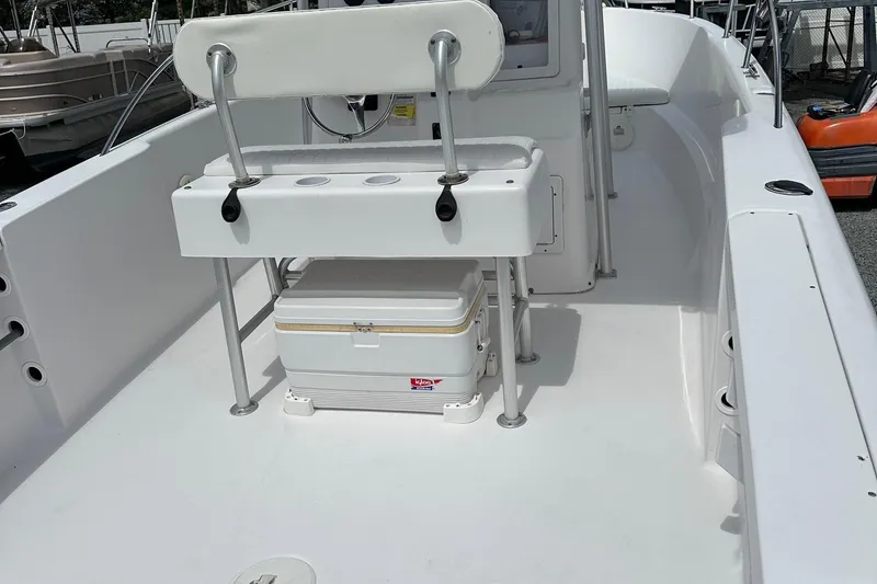 Slide: The Image of 2003 PROLINE Sport Center Console boat interior with seating and storage. - 9