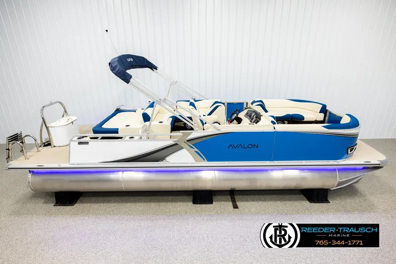 The Image of 2026 Avalon LSZ VRB pontoon boat with blue and white design, displayed indoors. - 1