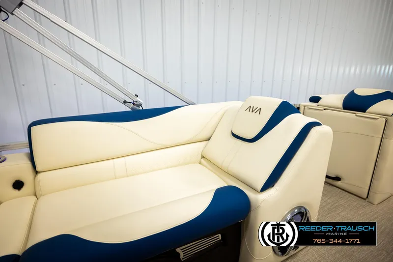 Slide: The Image of 2026 Avalon LSZ VRB boat interior with cream and blue seating, Reeder-Trausch Marine logo. - 26