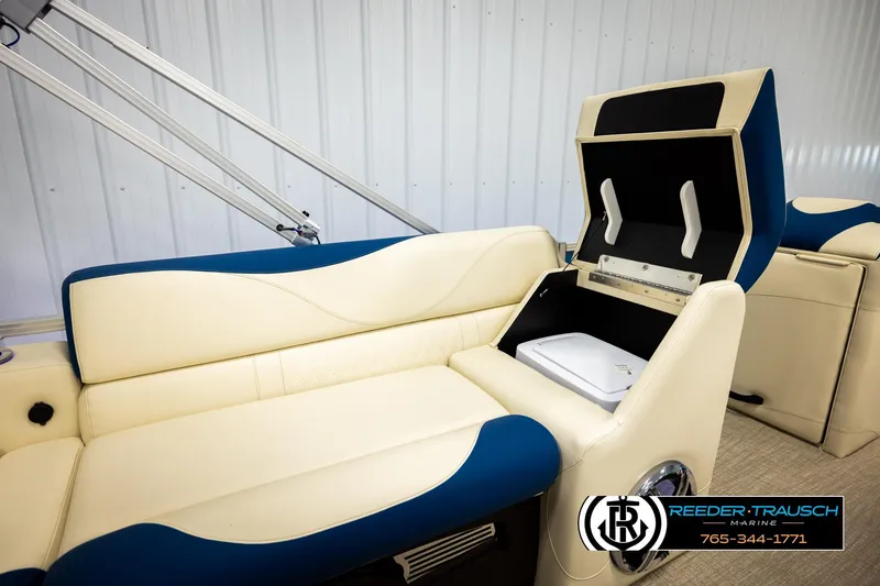 Slide: The Image of 2026 Avalon LSZ VRB boat interior with cream and blue seating, storage compartment open. - 27