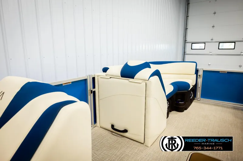 Slide: The Image of 2026 Avalon LSZ VRB boat interior with blue and white seating in a showroom. - 28