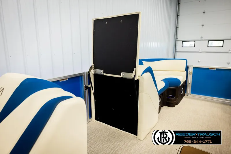 Slide: The Image of Interior of 2026 Avalon LSZ VRB boat with blue and white seating, Reeder-Trausch Marine logo. - 29