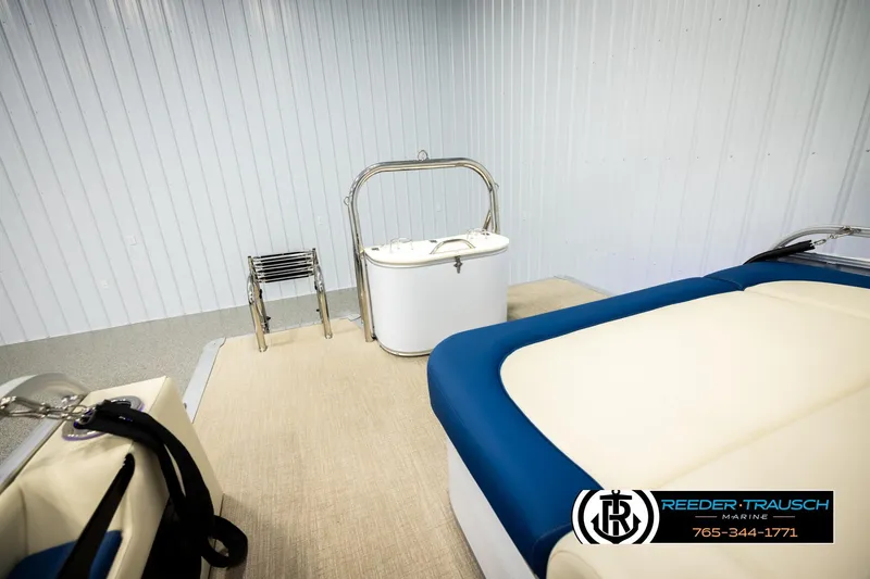 Slide: The Image of 2026 Avalon LSZ VRB boat interior with seating and storage, displayed in a showroom. - 30