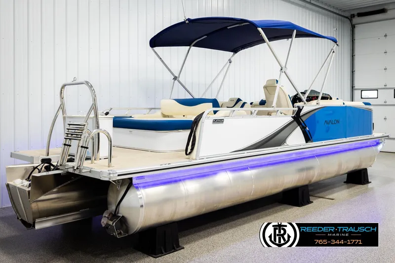 Slide: The Image of 2026 Avalon LSZ VRB pontoon boat with blue canopy in showroom. - 6