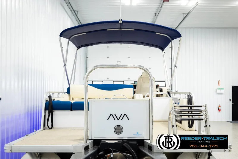 Slide: The Image of 2026 Avalon LSZ VRB pontoon boat with blue canopy in a showroom. - 7