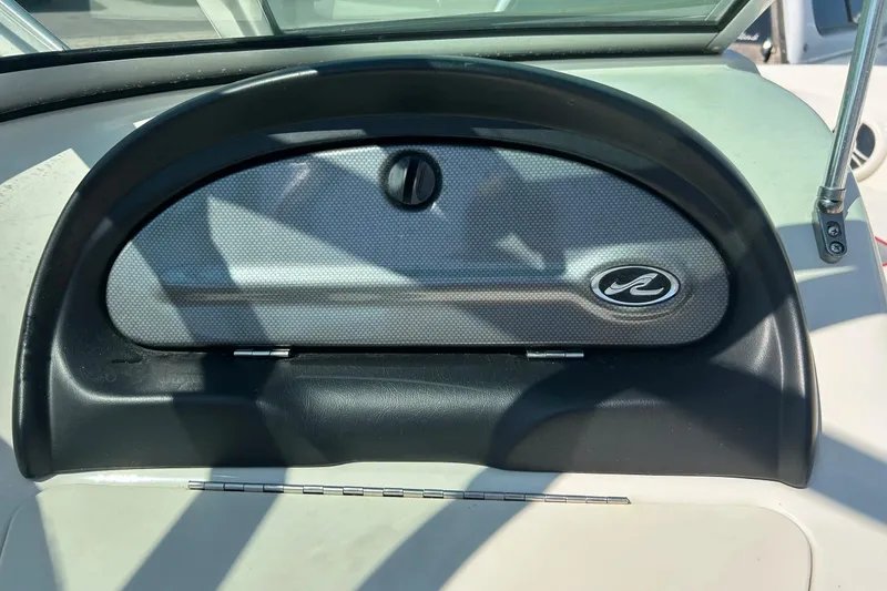 Slide: The Image of Dashboard of a 2008 Searay 205 SPORT boat with logo and compartment. - 28