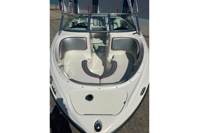 Slide: The Image of 2008 Searay 205 SPORT boat with white and gray interior, docked on pavement. - 3