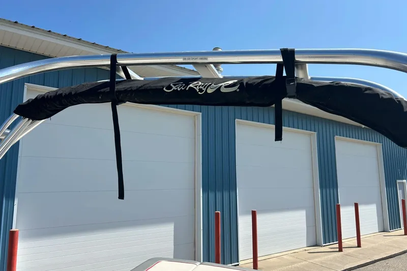 Slide: The Image of 2008 Searay 205 SPORT boat with covered wakeboard tower, blue building background. - 37