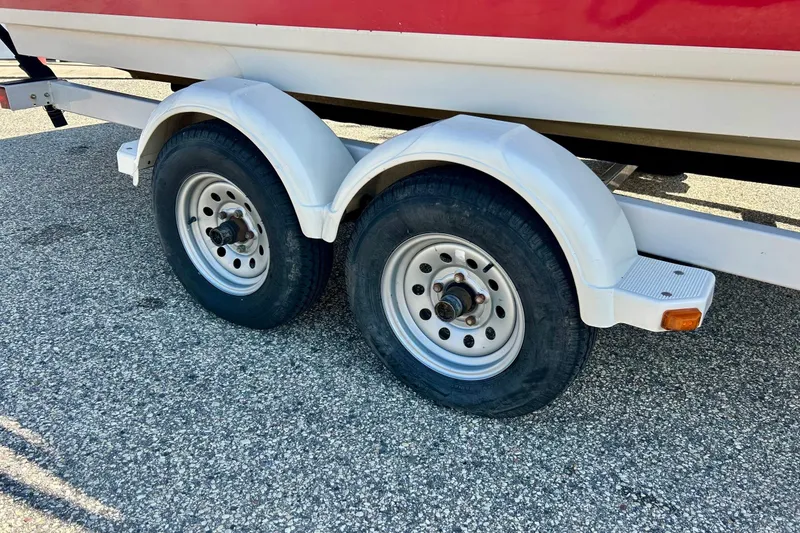 Slide: The Image of Trailer wheels of a 2008 Searay 205 SPORT boat on asphalt. - 5