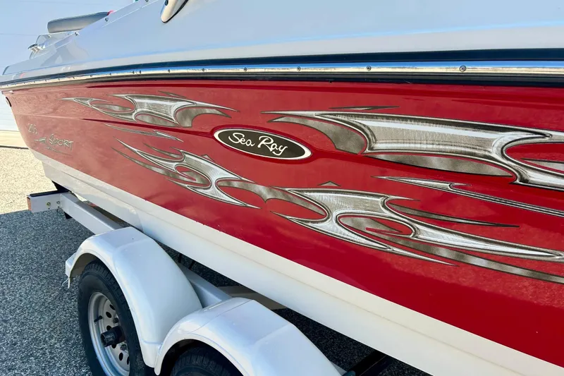 Slide: The Image of 2008 Searay 205 SPORT boat with red and silver flame graphics on trailer. - 6